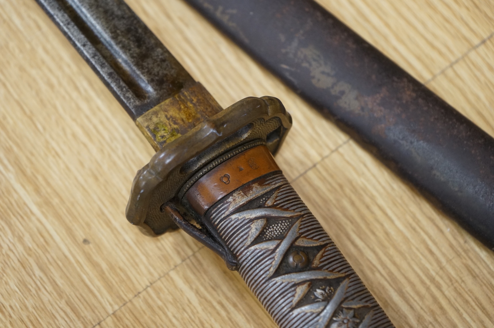 A Japanese World War II NCO‘s sword katana, regulation blade with fuller, stamped 33271, regulation aluminium hilt, brass guard, the spring catch still retains, in an iron scabbard